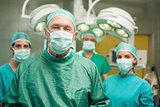 Smiling surgeon posing with a team