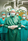 Smiling surgeon posing with a medical team