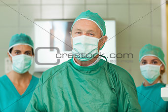 Surgeon with two interns behind him