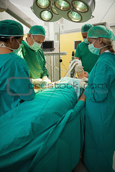Patient being operated by a team of surgeon