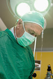 Surgeon under a surgical light