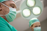 Two surgeon standing under a surgical light
