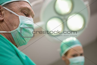 Two surgeon standing under a surgical light