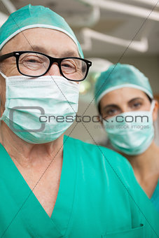 Man surgeon with glasses and a colleague