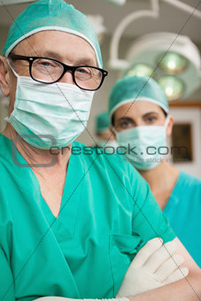 Surgeon crossing his arms with a colleague