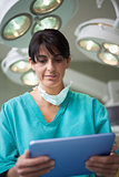 Woman surgeon holding a tactile tablet