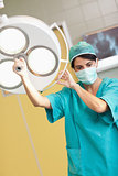 Woman surgeon holding a surgical light