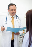 Smiling doctor talking to his patient