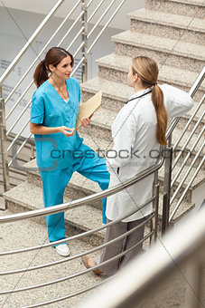 Nusre and doctor talking together in a stairwell