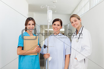Doctor standing in a hallway with a patient and a nurse