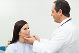 Doctor auscultating the neck of a patient