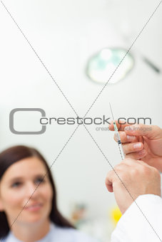 Doctor preparing an injection for a patient