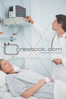 Doctor adjusting a monitor
