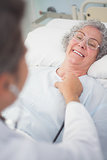 Elderly patient smiling to a doctor