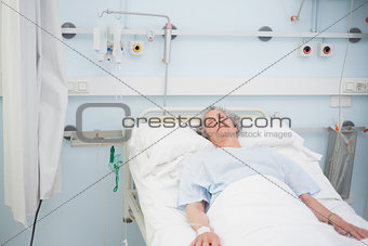 Elderly patient sleeping on a medical bed