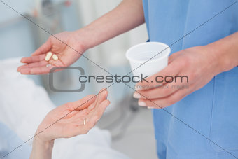 Nurse giving drugs to a patient