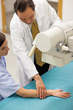 Doctor placing the arm of a patient on a table