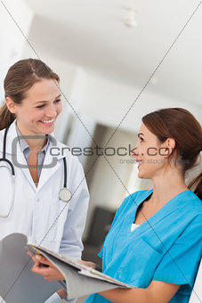 Doctor and nurse smiling while looking at each other