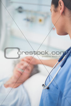 Nurse looking at a patient while touching her