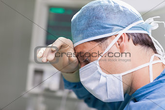 Doctor putting his hand on his forehead