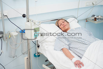 Woman lying on a medical bed with closed eyes