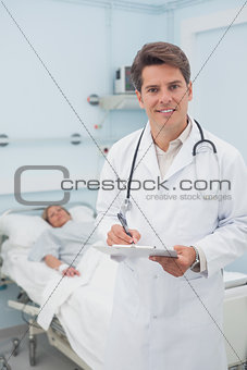 Doctor holding a chart while smiling