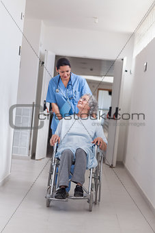 Nurse pushing a patient in a wheelchair