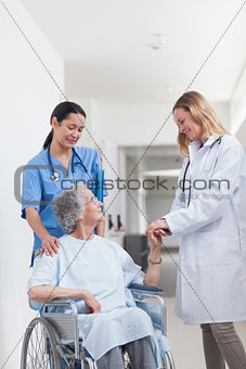 Doctor looking at a patient on a wheelchair