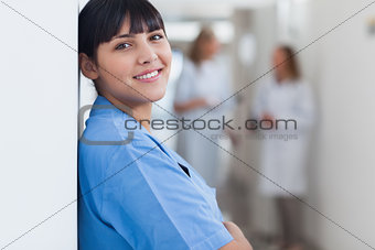 Nurse looking at camera in corridor