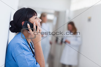 Smiling nurse holding a mobile phone