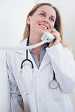 Smiling doctor holding a phone