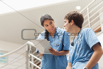 Nurse holding a clipboard on stairs