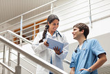 Female doctor holding a tablet computer on stairs
