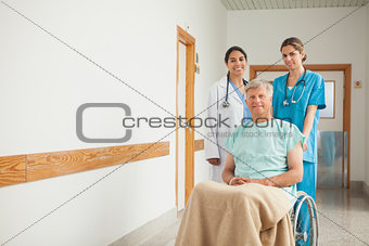 Patient in a wheelchair next to nurses