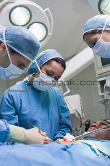 Doctors operating with surgical tools