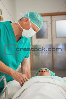 Surgeon touching a patient