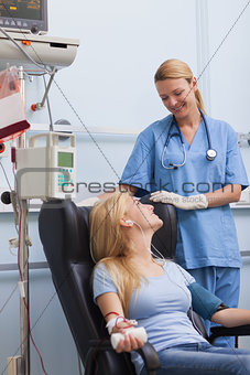 Blood donor sitting next to a nurse