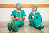 Surgeons having a break in the corridor