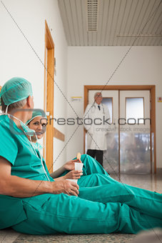 Surgeons talking next to a doctor