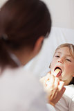 Doctor examining the mouth of a child