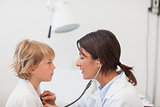 Doctor auscultating a child with a stethoscope