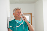 Surgeon smiling while holding a phone