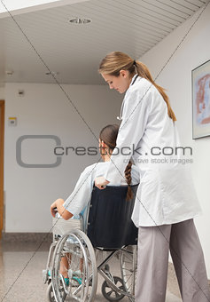 Doctor pushing a wheelchair