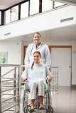 Patient sitting on a wheelchair next to a doctor