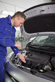 Mechanic showing an engine