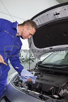 Mechanic looking at the dipstick