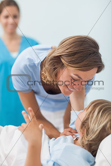 Child on a medical bed looking his mother