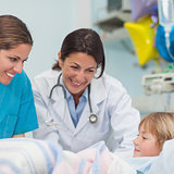 Doctor and nurse smiling to a child