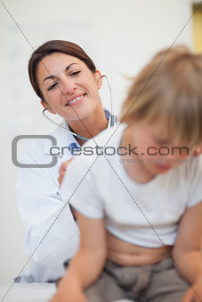Doctor examining breathing of a child with a stethoscope