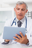 Doctor using a tablet computer